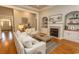 Bright living room with fireplace, built-in shelving, and hardwood floors at 4535 Carriage Run Circle, Murrells Inlet, SC 29576