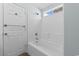 Clean white bathroom with a fully tiled tub and shower, a towel bar on the back of the door at 4591 Hidden Creek Ln., Myrtle Beach, SC 29579