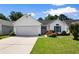 Inviting home with a well-manicured lawn, white siding, an attached garage, and colorful flowerbeds at 4591 Hidden Creek Ln., Myrtle Beach, SC 29579