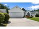 White home with an attached garage, a long driveway, and lovely landscaping at 4591 Hidden Creek Ln., Myrtle Beach, SC 29579
