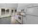 Bright kitchen features wood-look floors, granite countertops, tiled backsplash, and white appliances at 4591 Hidden Creek Ln., Myrtle Beach, SC 29579