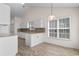 Bright kitchen features white cabinets, tiled backsplash, granite counters, and pendant lighting, offering a modern, inviting space at 4591 Hidden Creek Ln., Myrtle Beach, SC 29579