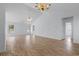 Spacious living room featuring high ceilings, wood-look floors, and large windows, creating a bright and airy atmosphere at 4591 Hidden Creek Ln., Myrtle Beach, SC 29579