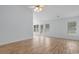 Bright living room featuring wood-look floors, a ceiling fan, and natural light, creating a comfortable and inviting space at 4591 Hidden Creek Ln., Myrtle Beach, SC 29579