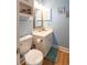 Powder blue bathroom with white vanity, a toilet, and a decorative mirror at 4741 Wild Iris Dr. # 303, Myrtle Beach, SC 29577