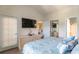 Bright bedroom with TV, dresser, and view to living area and bathroom at 4741 Wild Iris Dr. # 303, Myrtle Beach, SC 29577