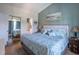 Comfortable bedroom with blue accents and an adjoining bathroom and closet at 4741 Wild Iris Dr. # 303, Myrtle Beach, SC 29577