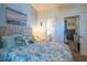 Inviting bedroom featuring beach themed decor, a ceiling fan, and a view to the bathroom at 4741 Wild Iris Dr. # 303, Myrtle Beach, SC 29577