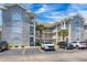 Beautiful condo complex featuring stone accents, covered balconies, and ample parking at 4741 Wild Iris Dr. # 303, Myrtle Beach, SC 29577