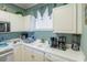 Bright kitchen with white cabinets, appliances, and ample counter space at 4741 Wild Iris Dr. # 303, Myrtle Beach, SC 29577
