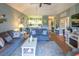 Open-concept living area with updated furniture, a ceiling fan, hardwood floors and a modern fireplace at 4741 Wild Iris Dr. # 303, Myrtle Beach, SC 29577