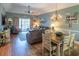 Cozy living and dining area with hardwood floors, a chandelier, and comfortable furnishings at 4741 Wild Iris Dr. # 303, Myrtle Beach, SC 29577