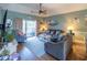 Inviting living room with modern ceiling fan, plush seating, and sliding door access to the outdoor balcony at 4741 Wild Iris Dr. # 303, Myrtle Beach, SC 29577