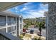 View of the parking lot and manicured landscaping at the Magnolia Place Condominiums under a bright blue, sunny sky at 4741 Wild Iris Dr. # 303, Myrtle Beach, SC 29577