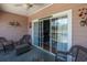 Covered porch with wicker furniture and view through sliding glass door at 4741 Wild Iris Dr. # 303, Myrtle Beach, SC 29577