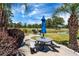 Picnic area with grill, table, and views of the golf course near a calm pond and mature trees at 4741 Wild Iris Dr. # 303, Myrtle Beach, SC 29577