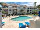 Outdoor pool area with comfortable lounge chairs and beautifully maintained landscaping in front of condo building at 4741 Wild Iris Dr. # 303, Myrtle Beach, SC 29577