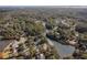 An aerial view shows homes near a lake surrounded by green trees and foliage at 487 Lantana Circle, Georgetown, SC 29440