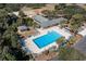 An aerial view of the community pool and surrounding amenities, including palm trees, lounge chairs and a park at 487 Lantana Circle, Georgetown, SC 29440