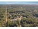 An aerial view shows the home nestled amongst lush trees near a river meeting the ocean at 487 Lantana Circle, Georgetown, SC 29440