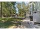 Expansive backyard featuring lush greenery, a gazebo, and a screened-in porch, ideal for outdoor entertaining at 487 Lantana Circle, Georgetown, SC 29440