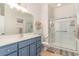 Updated bathroom with glass shower door, subway tile, and modern vanity with ample storage at 487 Lantana Circle, Georgetown, SC 29440