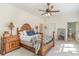 Spacious bedroom exhibiting a carved wood bed, a ceiling fan, and an ensuite bathroom at 487 Lantana Circle, Georgetown, SC 29440