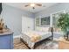 Neutral bedroom showcasing wood flooring, a double bed, multiple windows, and an octopus painting at 487 Lantana Circle, Georgetown, SC 29440