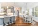Open-concept kitchen and dining area, featuring hardwood floors, a kitchen island, and pendant lighting at 487 Lantana Circle, Georgetown, SC 29440