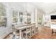Bright dining room features a modern light fixture, hardwood floors and multiple large windows at 487 Lantana Circle, Georgetown, SC 29440