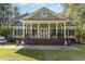 Charming home featuring a large front porch with stately columns and beautiful brick stairs and landscaped front yard at 487 Lantana Circle, Georgetown, SC 29440