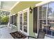 Charming front porch featuring rocking chairs, an elegant entrance and black shutters at 487 Lantana Circle, Georgetown, SC 29440