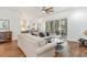 Open living room boasts hardwood floors, neutral furnishings, and access to an outdoor patio at 487 Lantana Circle, Georgetown, SC 29440