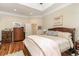 Well-lit primary bedroom features a large bed, hardwood floors, ample closet space, and a tray ceiling at 487 Lantana Circle, Georgetown, SC 29440