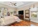 Main bedroom features tray ceilings, hardwood floors, TV, and outdoor access at 487 Lantana Circle, Georgetown, SC 29440