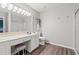 Well-lit bathroom featuring double vanity, walk-in shower, and wood-look floors at 5036 Billy K Trail, Myrtle Beach, SC 29579
