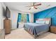 Cozy bedroom featuring a blue accent wall, ceiling fan, and natural light at 5036 Billy K Trail, Myrtle Beach, SC 29579