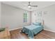 Comfortable bedroom with a ceiling fan, wood floors, and bright natural light from the window at 5036 Billy K Trail, Myrtle Beach, SC 29579