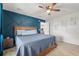 Comfortable bedroom with blue accent wall, ceiling fan, and neutral carpet at 5036 Billy K Trail, Myrtle Beach, SC 29579