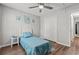 Bright bedroom with a ceiling fan, wood floors, closet, and a tranquil window view at 5036 Billy K Trail, Myrtle Beach, SC 29579