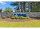 Entrance sign for Walkers Woods at Carolina Forest set amidst lush landscaping and a stone wall feature at 5036 Billy K Trail, Myrtle Beach, SC 29579