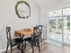 Cozy dining area with a small table and three chairs located next to a sliding glass door at 5036 Billy K Trail, Myrtle Beach, SC 29579