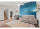 Open floor plan with a staircase and a comfortable seating arrangement and a bright blue accent wall at 5036 Billy K Trail, Myrtle Beach, SC 29579