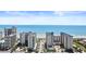 Expansive aerial view of oceanfront resort with tall buildings, a sunny beach, and ocean views at 5200 N Ocean Blvd. # 833, Myrtle Beach, SC 29577