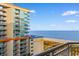 View from the balcony of the ocean, beach, and neighboring buildings at 5200 N Ocean Blvd. # 833, Myrtle Beach, SC 29577