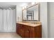 Bathroom features a double vanity, large mirror, shower with curtain, and tile flooring at 5200 N Ocean Blvd. # 833, Myrtle Beach, SC 29577