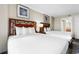 Inviting bedroom features two beds with dark wood headboards and beach-themed wall art at 5200 N Ocean Blvd. # 833, Myrtle Beach, SC 29577