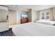 Bright bedroom features two beds, dresser with TV, and access to the balcony at 5200 N Ocean Blvd. # 833, Myrtle Beach, SC 29577
