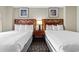 Bright bedroom featuring two beds with dark wood headboards and beach-themed wall art at 5200 N Ocean Blvd. # 833, Myrtle Beach, SC 29577