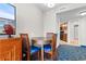 Cozy dining area features a round wood table with four chairs and is adjacent to the kitchen at 5200 N Ocean Blvd. # 833, Myrtle Beach, SC 29577